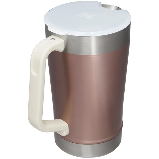 A beige-colored Stanley Classic Pitcher with a stainless steel lid and a white handle.