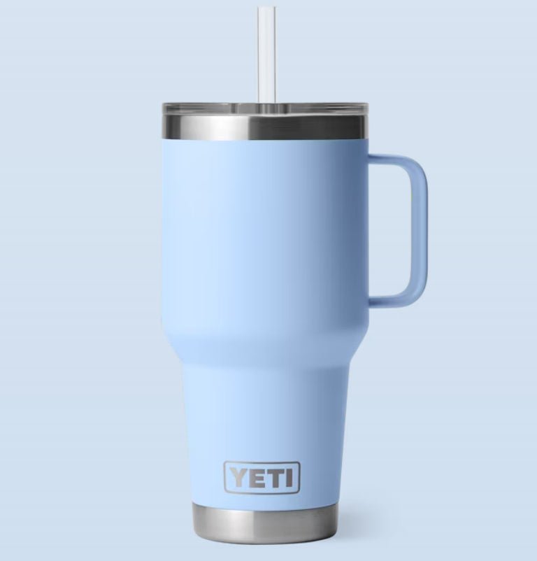 Blue YETI mug with a straw on a light blue background  35-oz-